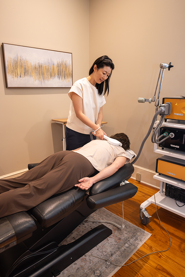 Dr. Helen Ly administering TMS treatment to a patient at Integrative Neuroscience
